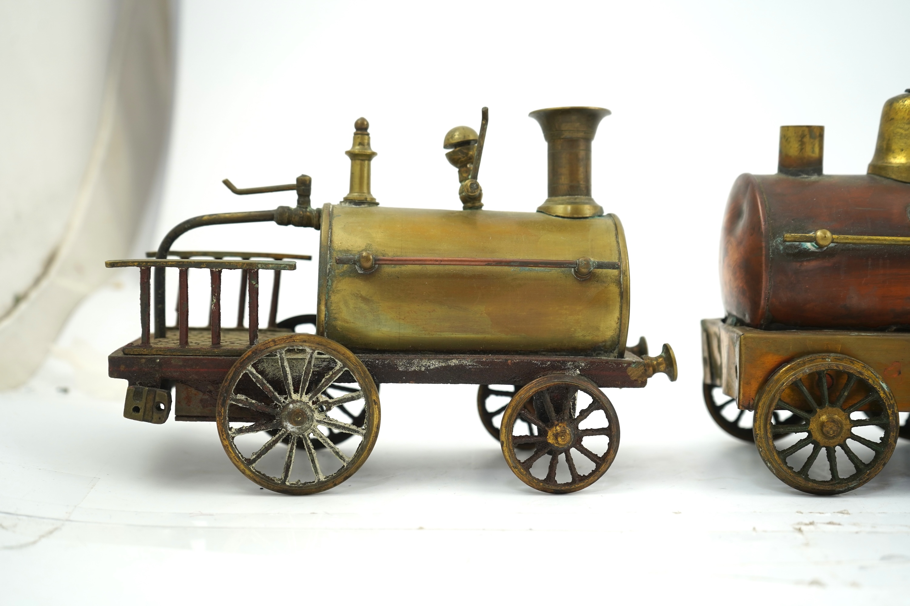 Three late 19th or early 20th century brass and copper live steam locomotives; a 2-2-4, ‘Monarch’, gauged to run on approximately 4 1/2 inch track, 33cm long frames, a 2-2-2, ‘Dragon’, gauged to run on approximately 3 1/